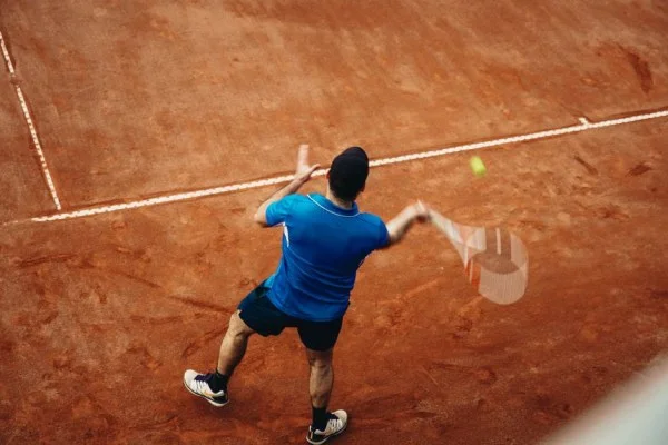 tennis player forehand topspin hard court action