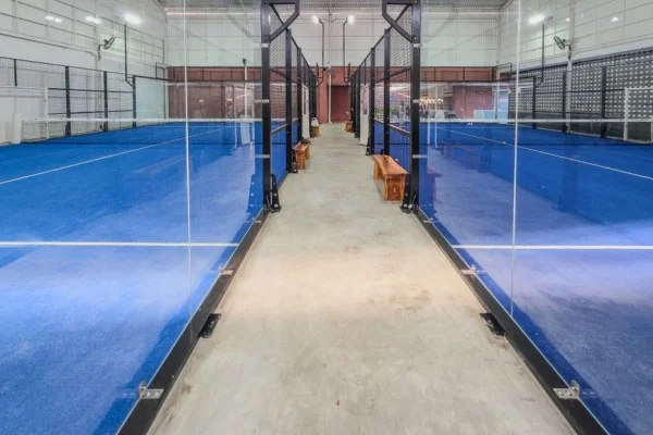 indoor tennis arena court under lights